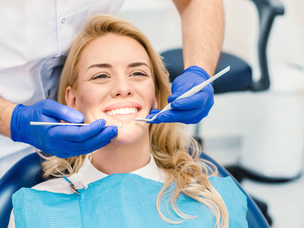 Young woman smiling during her dental appointment.