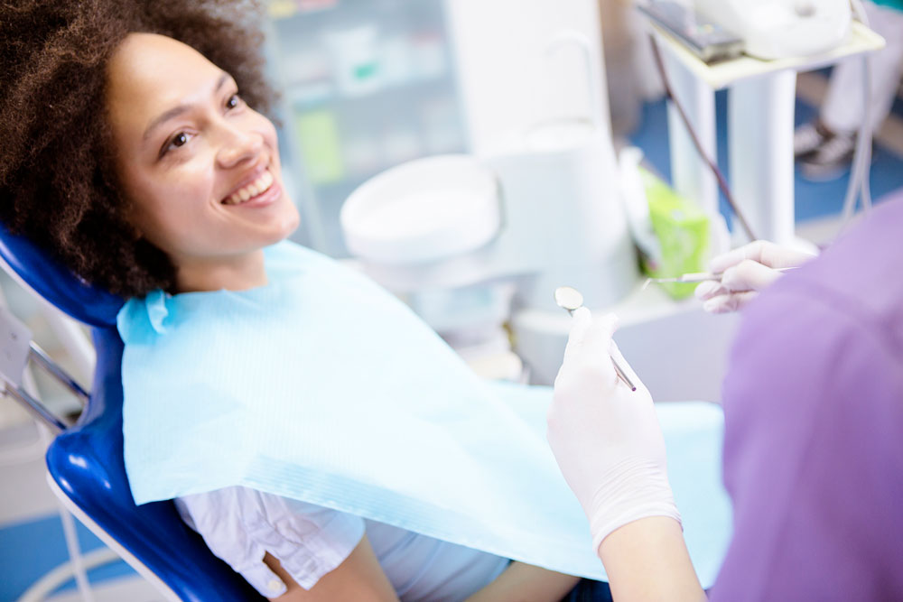 Young woman discussing dental hygiene with her dentist